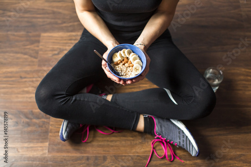 Fitness woman with oatmeal porridge
