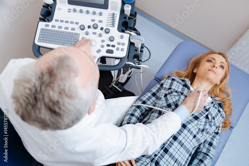 Involved patient having neck vessels ultrasound checkup in the clinic