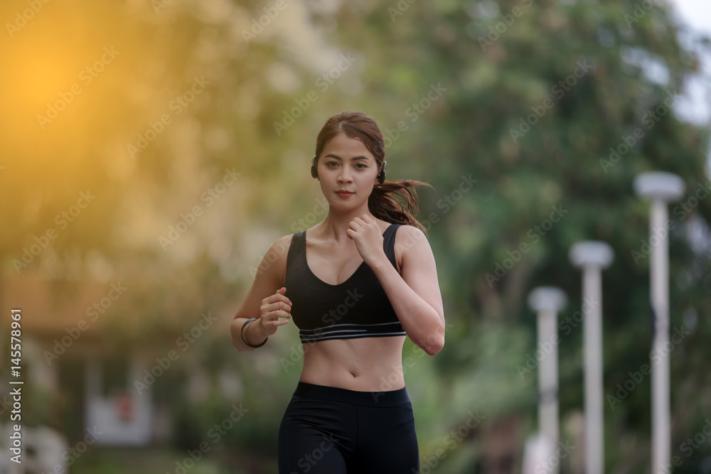 Running woman. Female runner jogging during outdoor on road .Young mixed race girl jogging Running woman. Female runner jogging during outdoor on road .Young mixed race girl jogging