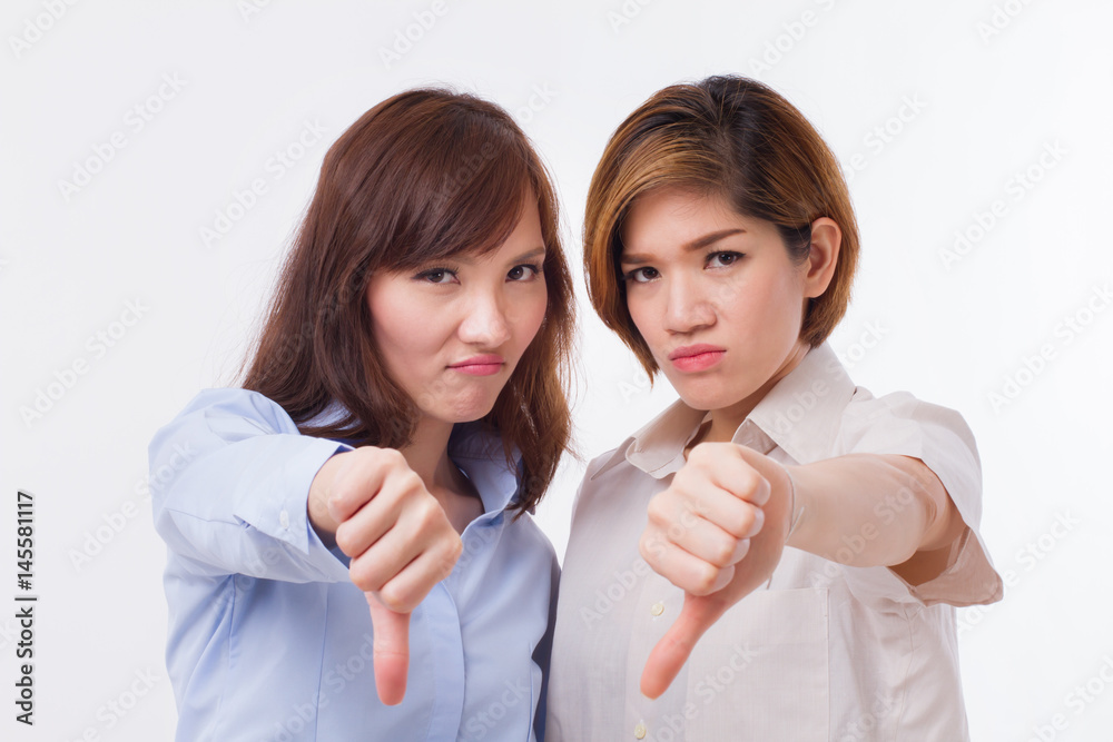 frustrated, angry women giving thumb down pose frustrated, angry women giving thumb down pose