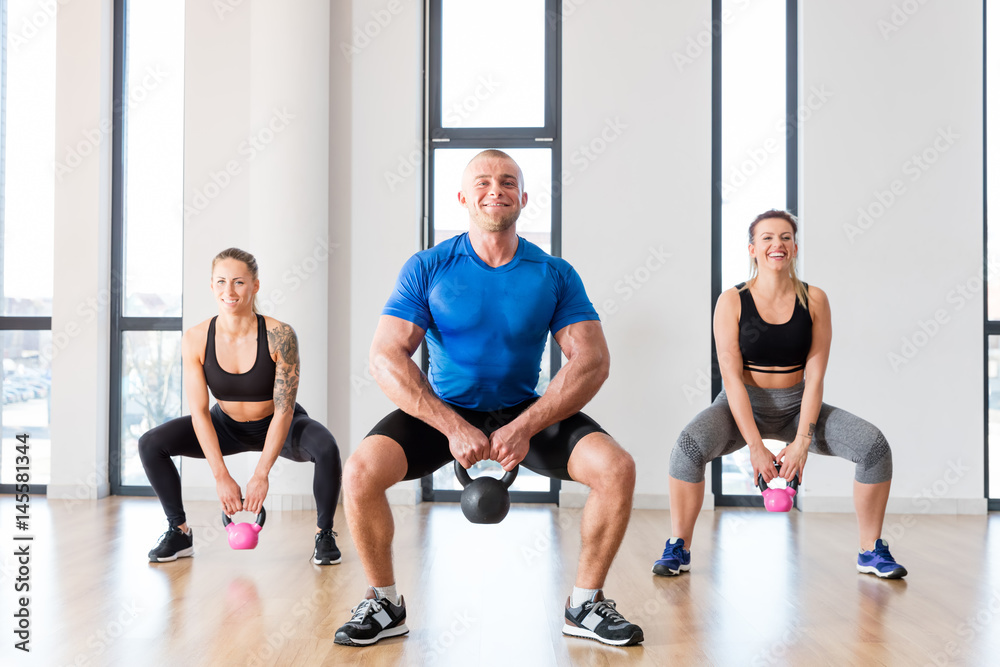Fototapeta premium Crossfit group workout with kettlebells.