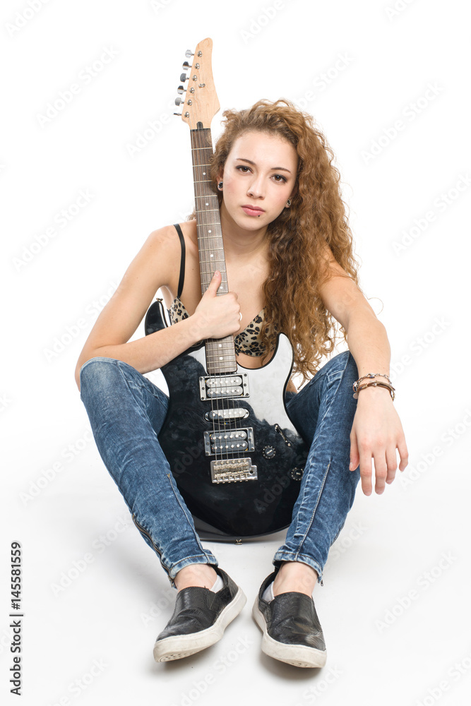 Young guitarist girl posing on white background; Young guitarist girl posing on white background;