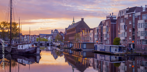 Netherlands Leiden Galgewater, View of sunrise in the morning with houses along side the Galgewater canal with boats resting in the water photo