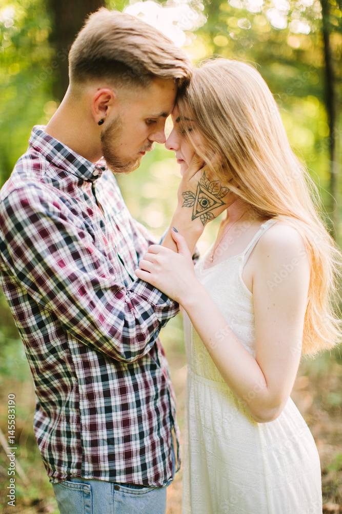 Beautiful Love story in the woods. Portrait of young stylish couple. Beautiful Love story in the woods. Portrait of young stylish couple.
