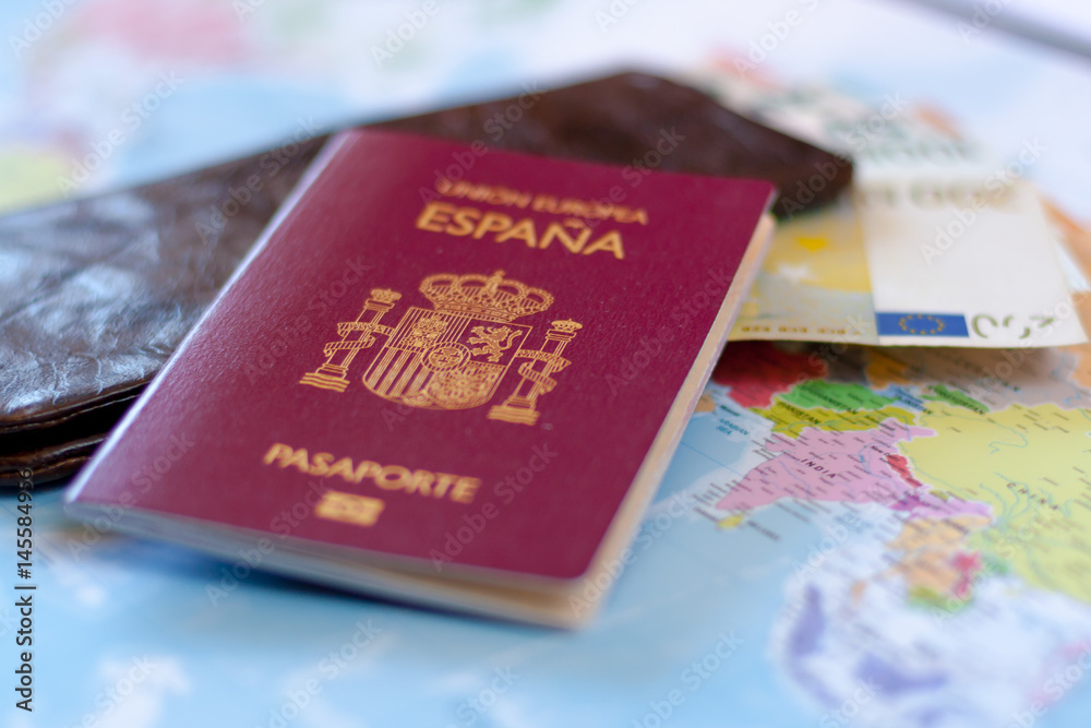 Spanish travel passport on the wallet with euro cash. Spanish citizenship. Spanish travel passport on the wallet with euro cash. Spanish citizenship.