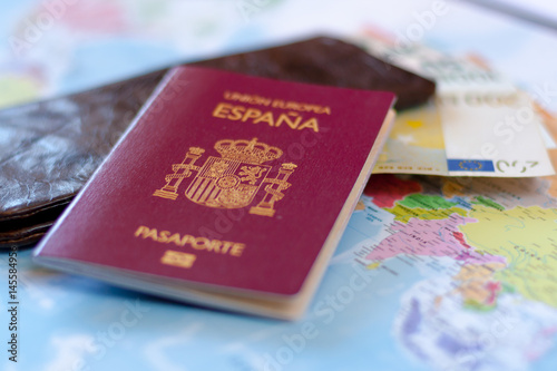 Spanish travel passport on the wallet with euro cash. Spanish citizenship. photo