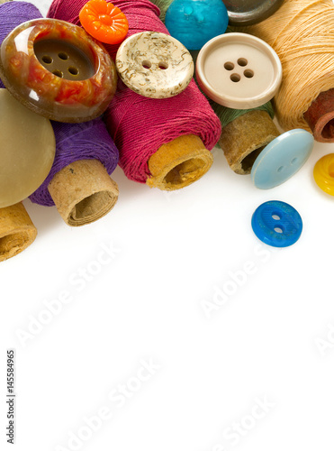 sewing buttons and thread isolated on white