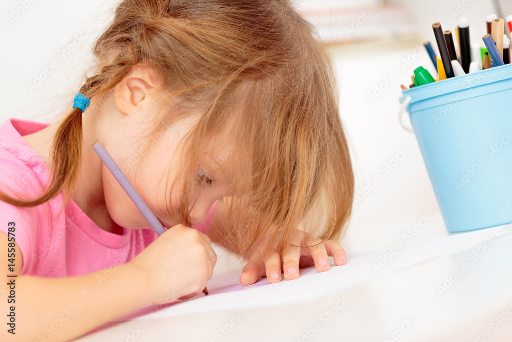 Small girl drawing with colourful pencils Small girl drawing with colourful pencils