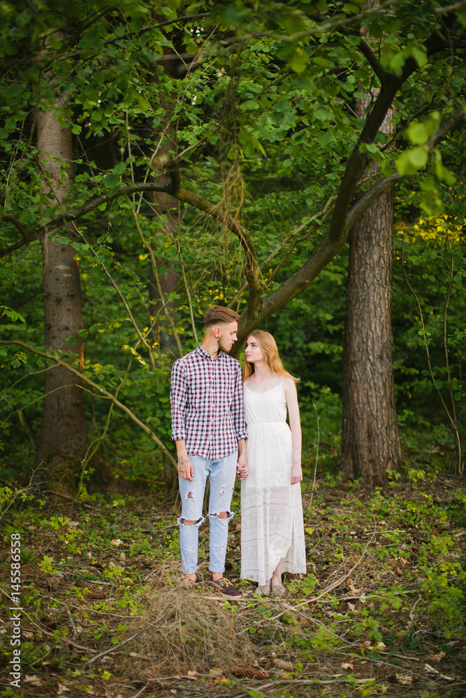 Beautiful Love story in the woods. Portrait of young stylish couple. Beautiful Love story in the woods. Portrait of young stylish couple.