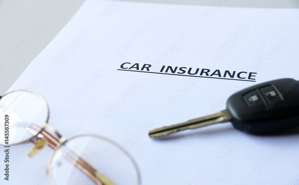 Car insurance text and key on paper Car insurance text and key on paper