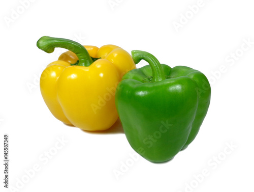 Close-up of yellow and green ripe vivid color bell peppers with stem isolated on white background