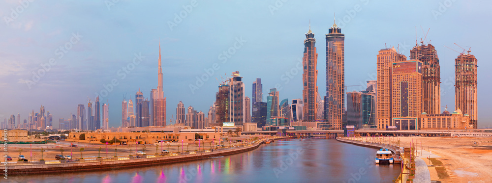 DUBAI, UAE - MARCH 27, 2017: The skyline over the new Canal and Downtown in sunset light.
