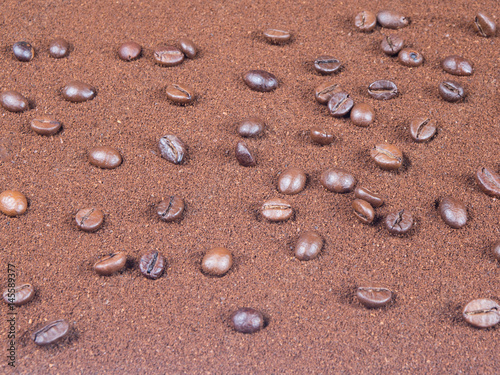 Grinded coffee background with scattered grains from top view
