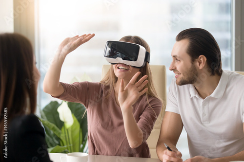 Cuadro en lienzo Business team of three people working on virtual reality applications and games,