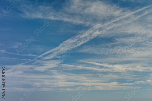 Blue sky with clouds and airplane trails. Beautiful background abstract Nature composition. © iamjura