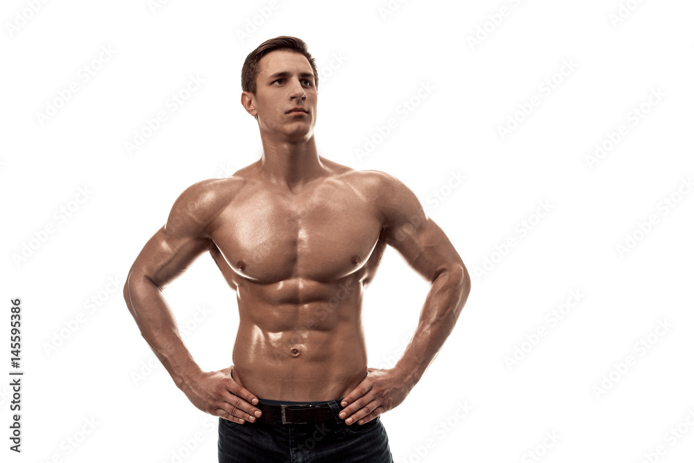 Muscular handsome young man with naked torso. Isolated on white background. Copy space