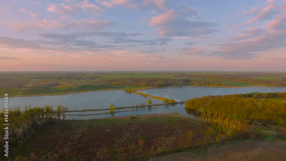 Aerial felled forest near river canal. Environmental consequences. Natural disaster. Evening Aerial felled forest near river canal. Environmental consequences. Natural disaster. Evening