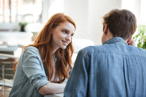Interested young student looking at her boyfriend