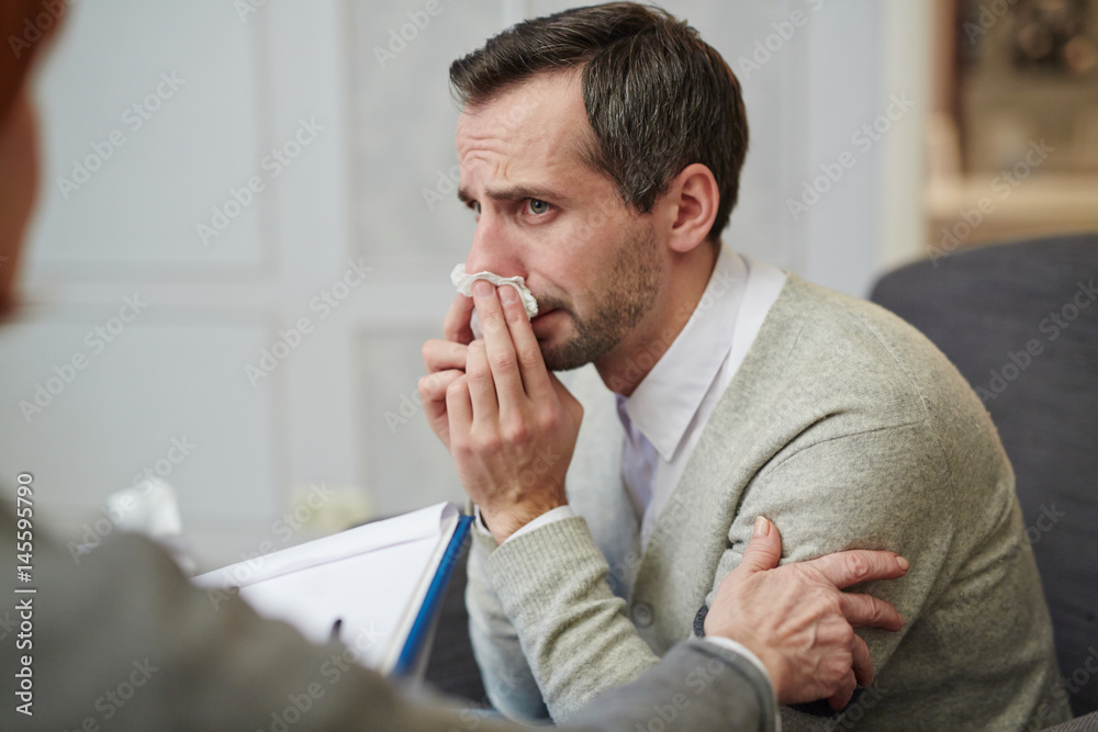 Man addicted to alcohol wiping tears during conversation with psychologist Man addicted to alcohol wiping tears during conversation with psychologist