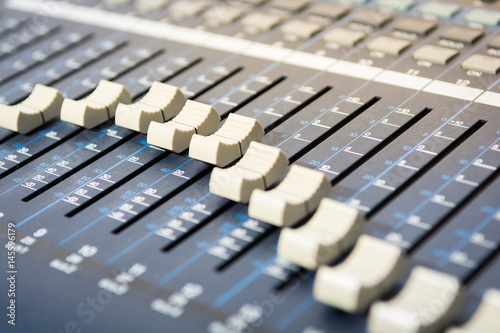 Sound mixer. Professional audio mixing console with lights, buttons, faders and sliders.