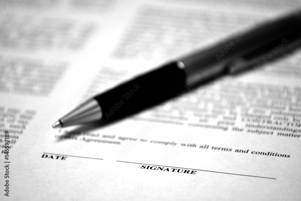 Contract on Desk with Black Pen Contract on Desk with Black Pen