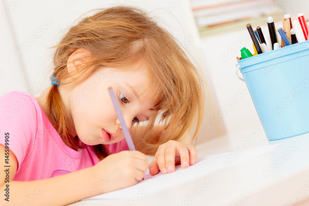 Small girl drawing with colourful pencils Small girl drawing with colourful pencils