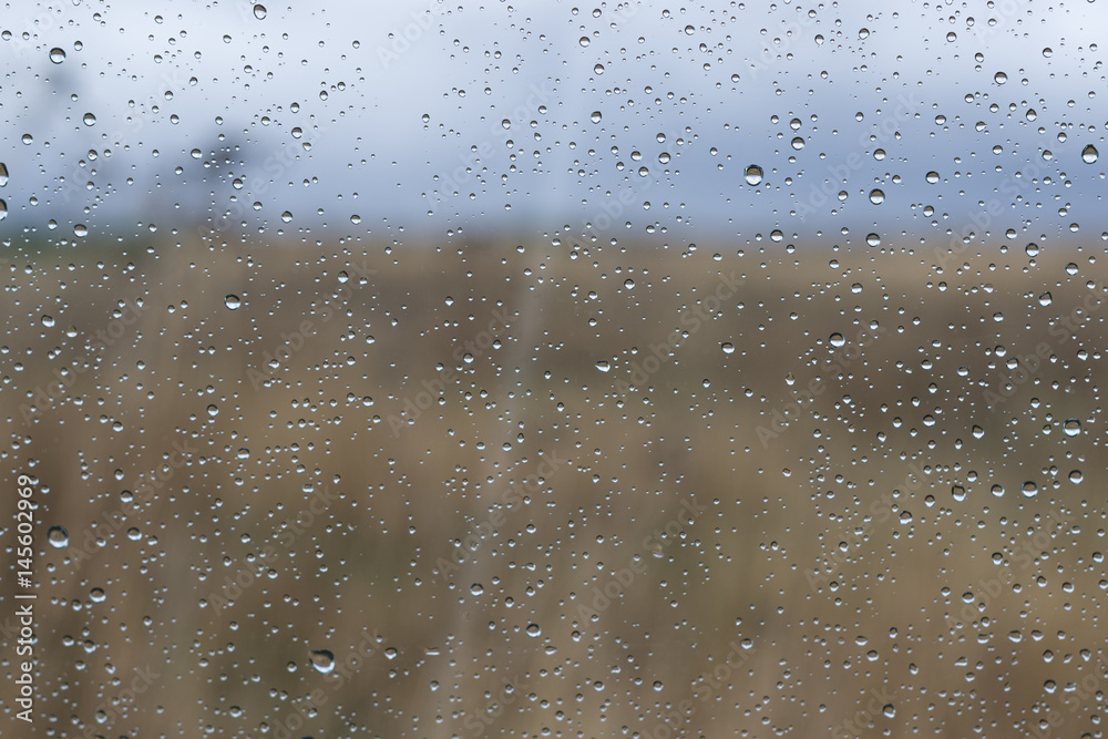 Natural landscape outside the window with rain drops on the glass. Natural landscape outside the window with rain drops on the glass.