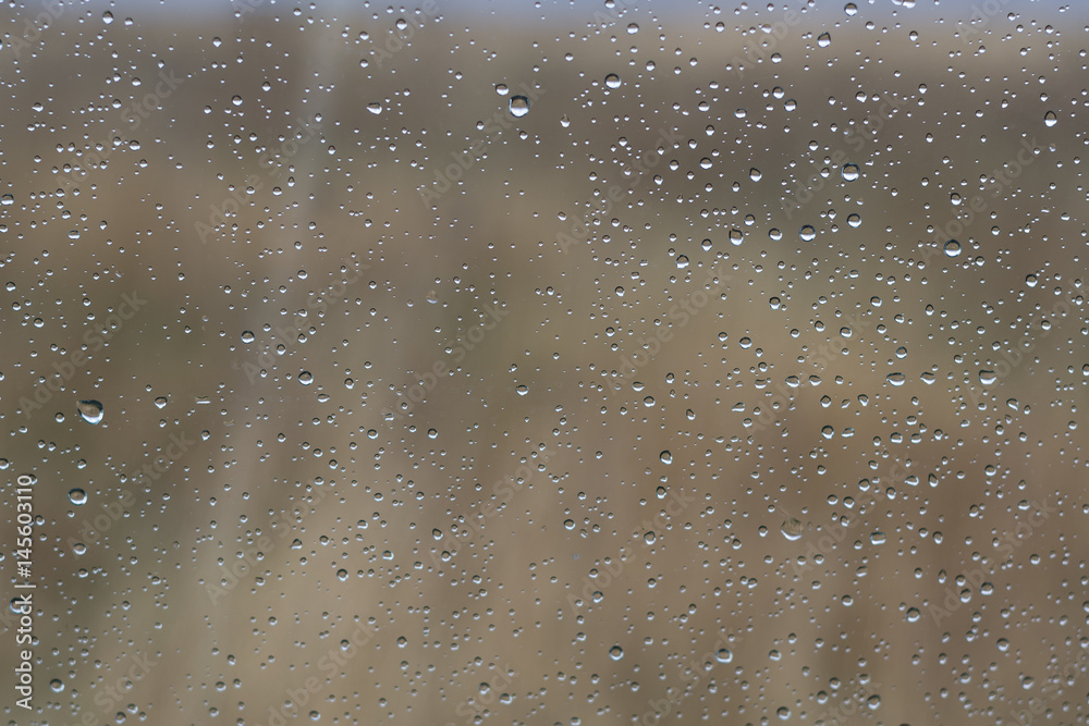 Rain drops on the glass with natural background outside the window. Rain drops on the glass with natural background outside the window.