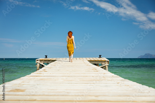 red haired woman at ocean pier in sunny weather © ASK-Fotografie