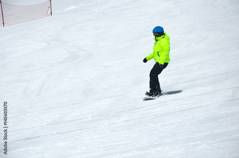 People snowboarding on snow of beautiful slopes of the Caucasus Mountains