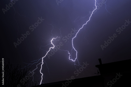 Lightning Behind House Roof Top