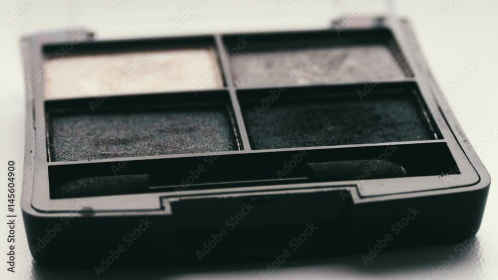 Gray shades of eyeshadow,Close up of makeup Eyebrow brush moving over eye shadows Gray shades of eyeshadow,Close up of makeup Eyebrow brush moving over eye shadows