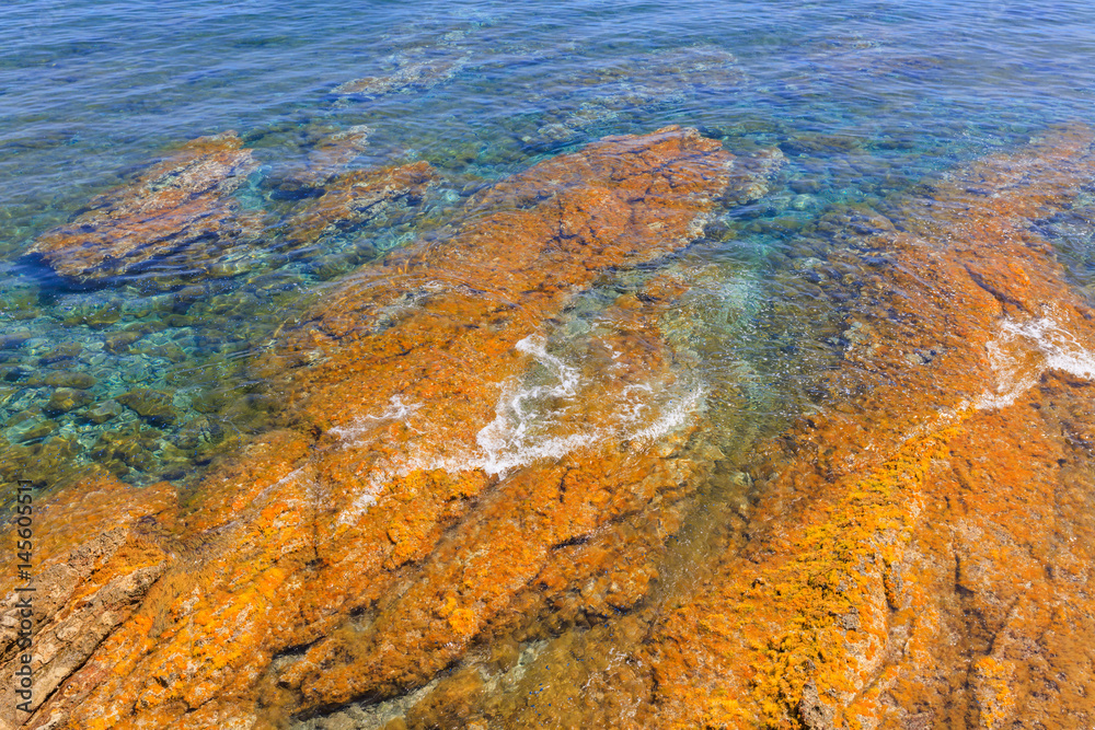 Colorful natural texture with blue sea and yellow rocks
