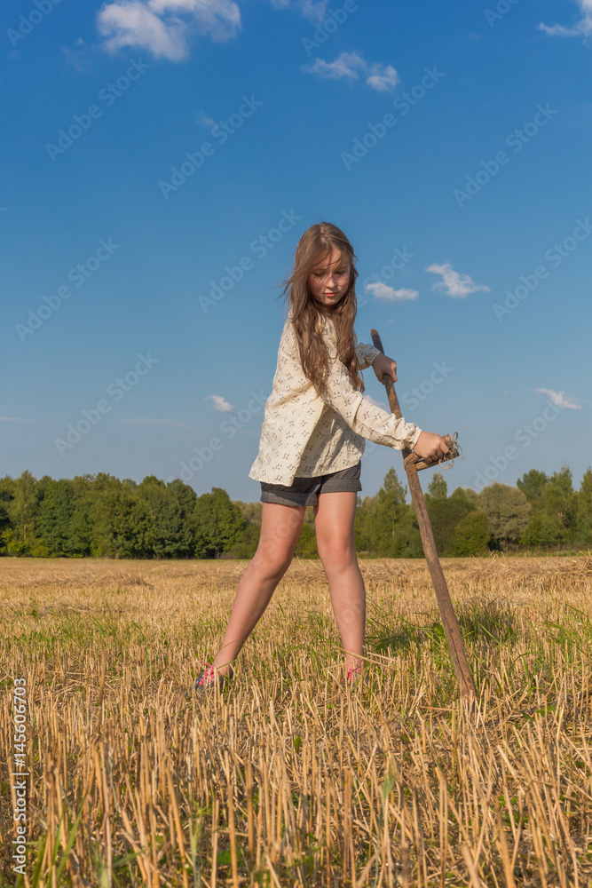 Teengirl with a scythe at summer field Teengirl with a scythe at summer field