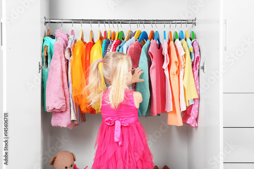 Cute small girl in wardrobe...