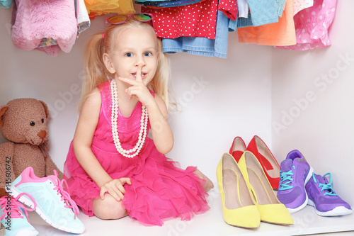 Cute small girl in wardrobe...