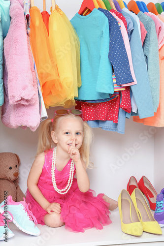Cute small girl in wardrobe...