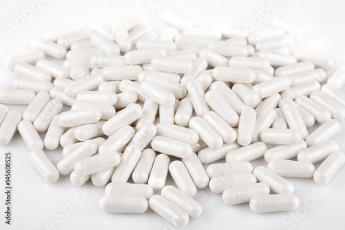 Glucosamine caplets on a white surface. Caplets isolated on white background. photo