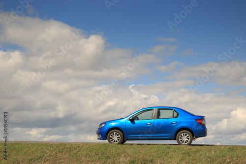 GOMEL, BELARUS - 16 April 2017: Beautiful blue car against the sky with clouds