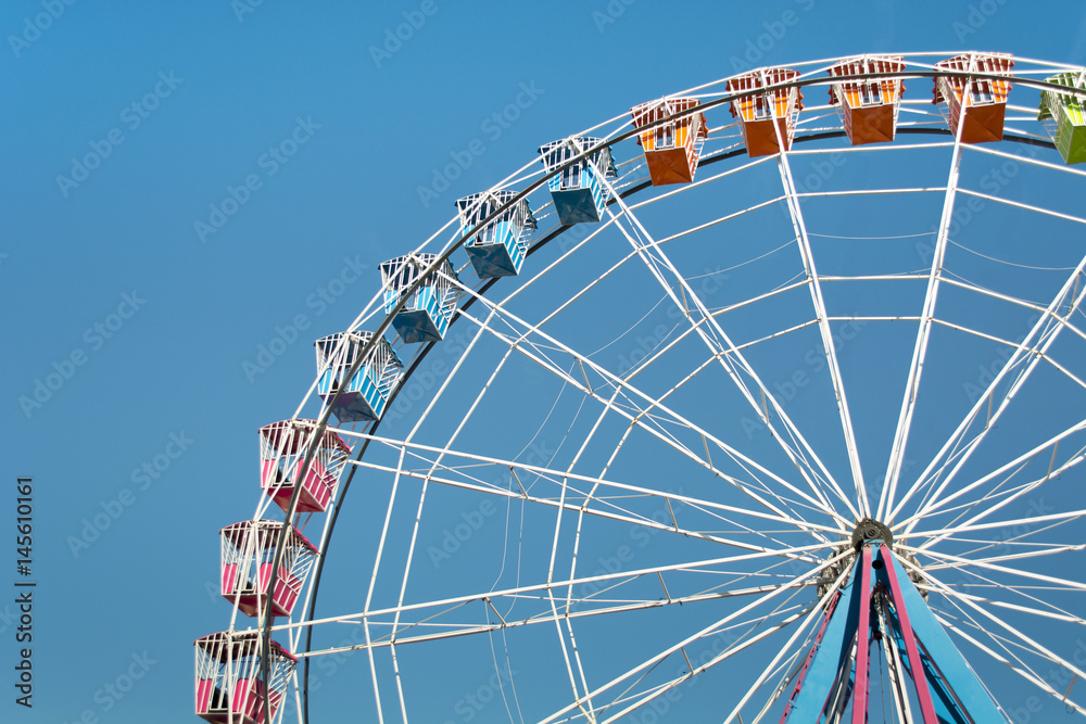 Colorful Amusement Park Big Wheel on Clear Blue Sky Colorful Amusement Park Big Wheel on Clear Blue Sky