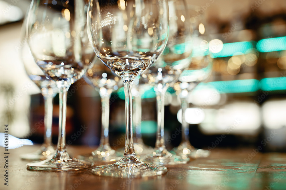 Close up picture of empty glasses on the wooden counter in restaurant Close up picture of empty glasses on the wooden counter in restaurant