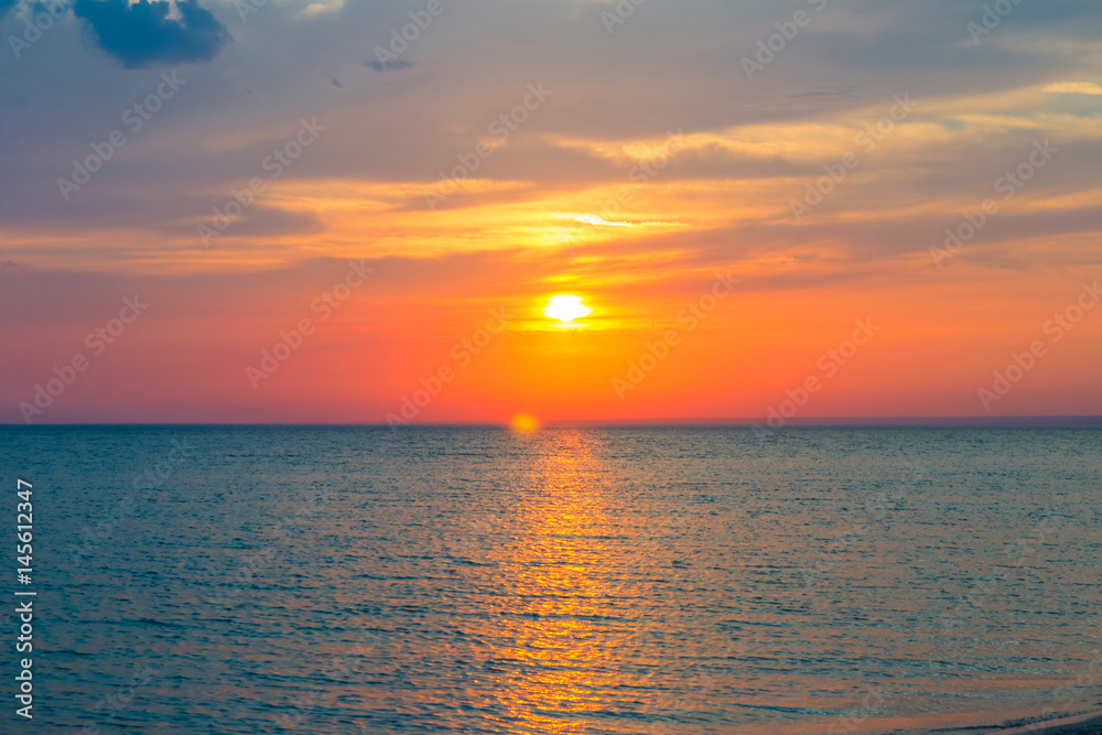Obraz premium Beautiful sunset over the Black Sea in the summer.The bird flying over water. Sea landscape. Nature composition