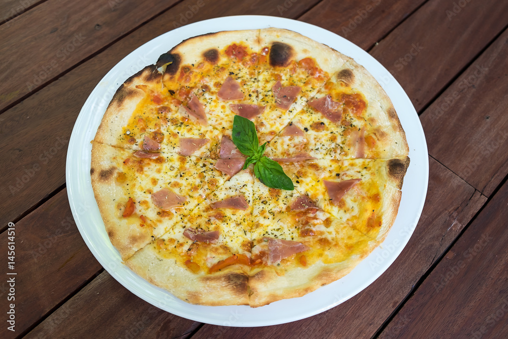  Parma Ham Pizza in white plate on wood table