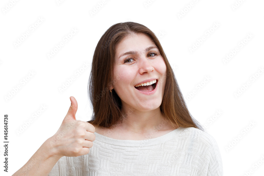 Portrait of a young brunette woman in a light jumper with a contented expression looking directly at the camera and showing thumb up isolated on white background. Demonstration of various emotions. Portrait of a young brunette woman in a light jumper with a contented expression looking directly at the camera and showing thumb up isolated on white background. Demonstration of various emotions.