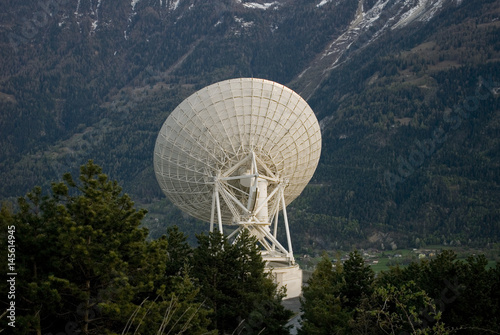 Landscape: white radio telescope during sunset on the Swiss mountains, on a spring day, Alps, Switzerland