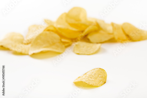 Crispy potato chips isolated on white background  close-up