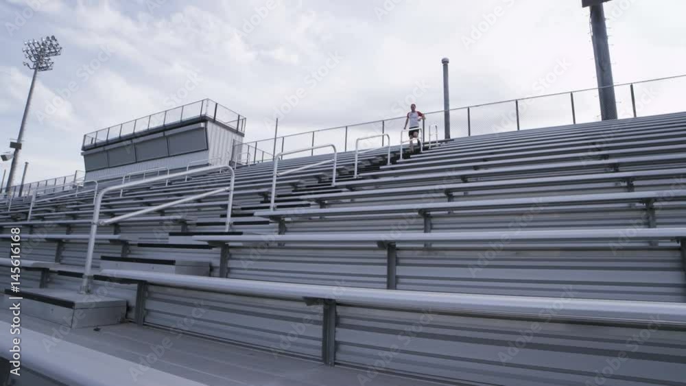 man running down bleachers man running down bleachers
