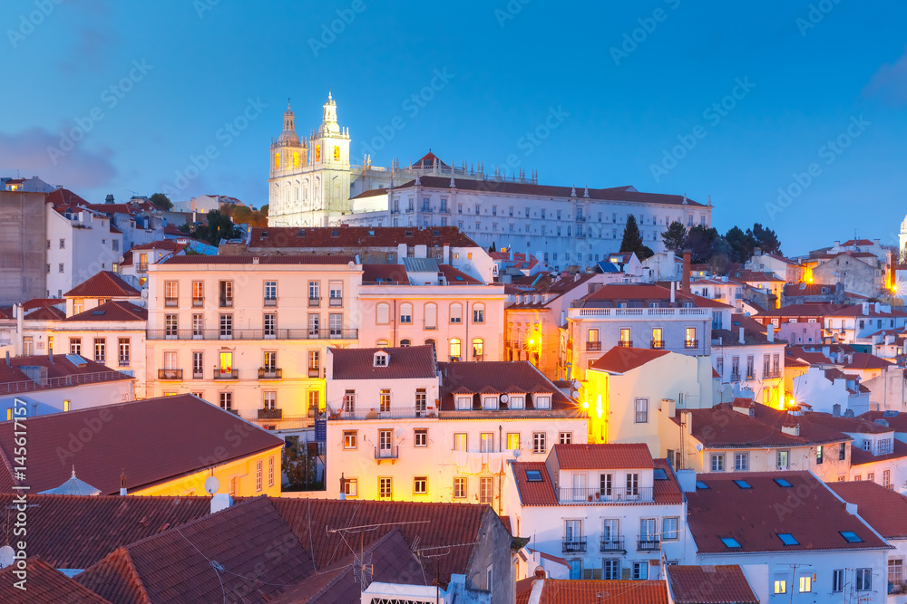 Scenic view of Alfama, the oldest district of the Old Town, with Monastery of Sao Vicente de Fora during evening blue hour, Lisbon, Portugal