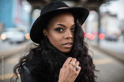 Tableau sur toile A beautiful, tattooed, black woman poses in the streets of Brooklyn, New York City