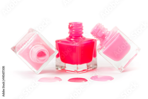 Stack of pink nail polish isolated on white background